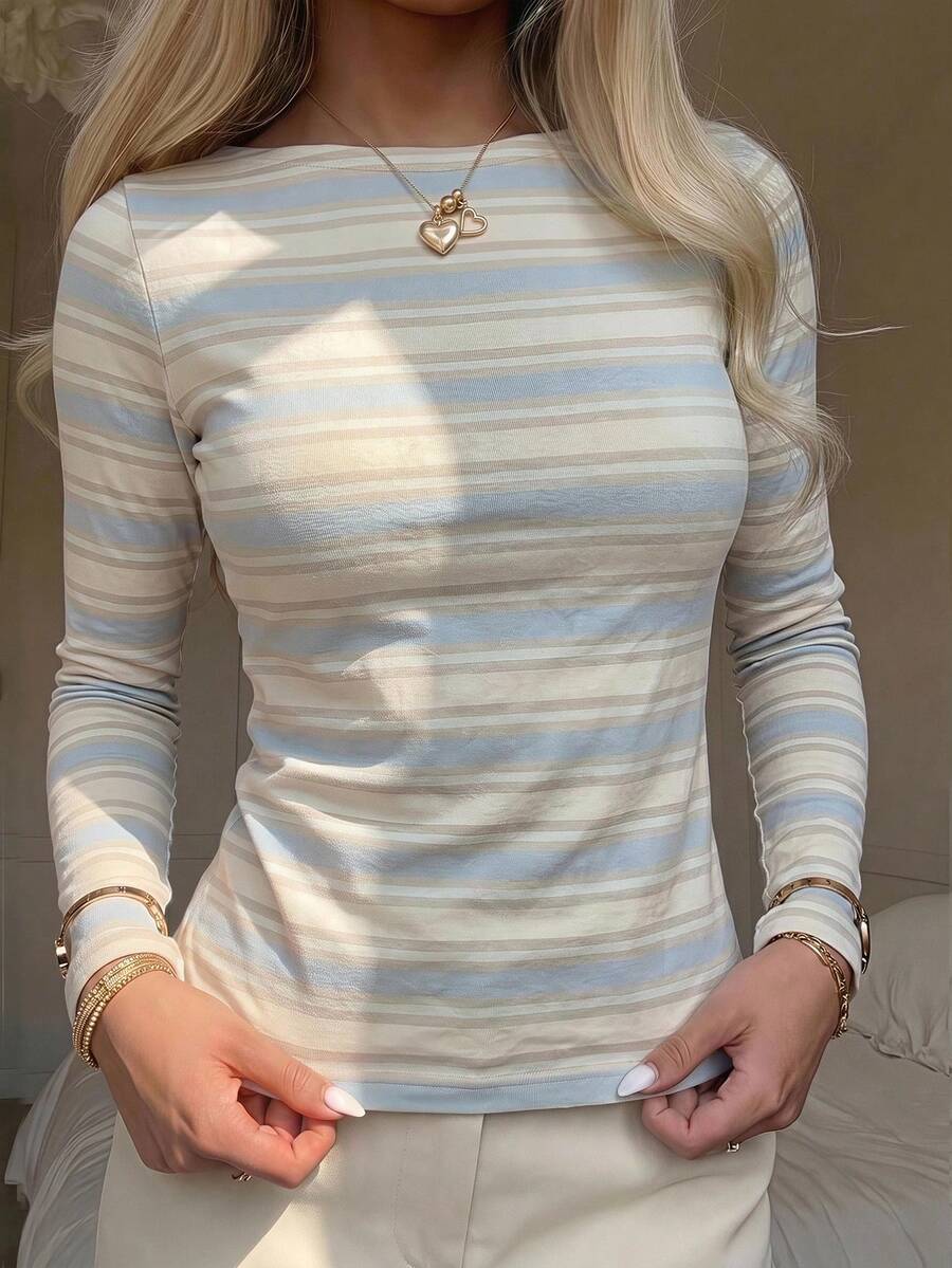 Casual CovetEZ long sleeve T-shirt with leopard-style random print, round neck, loose fit, and asymmetrical detail