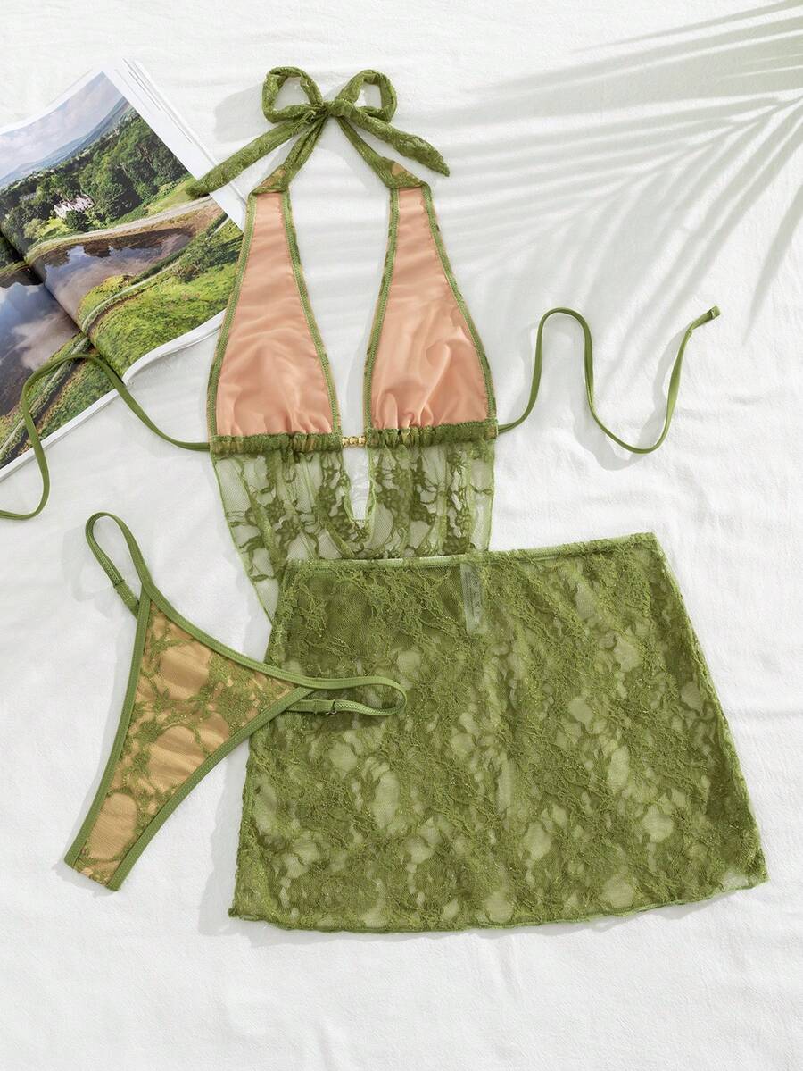 Women's black 3-piece bikini set with halter triangle top, backless design, ruched thong bottoms, and matching lace skirt for beach or vacation wear.