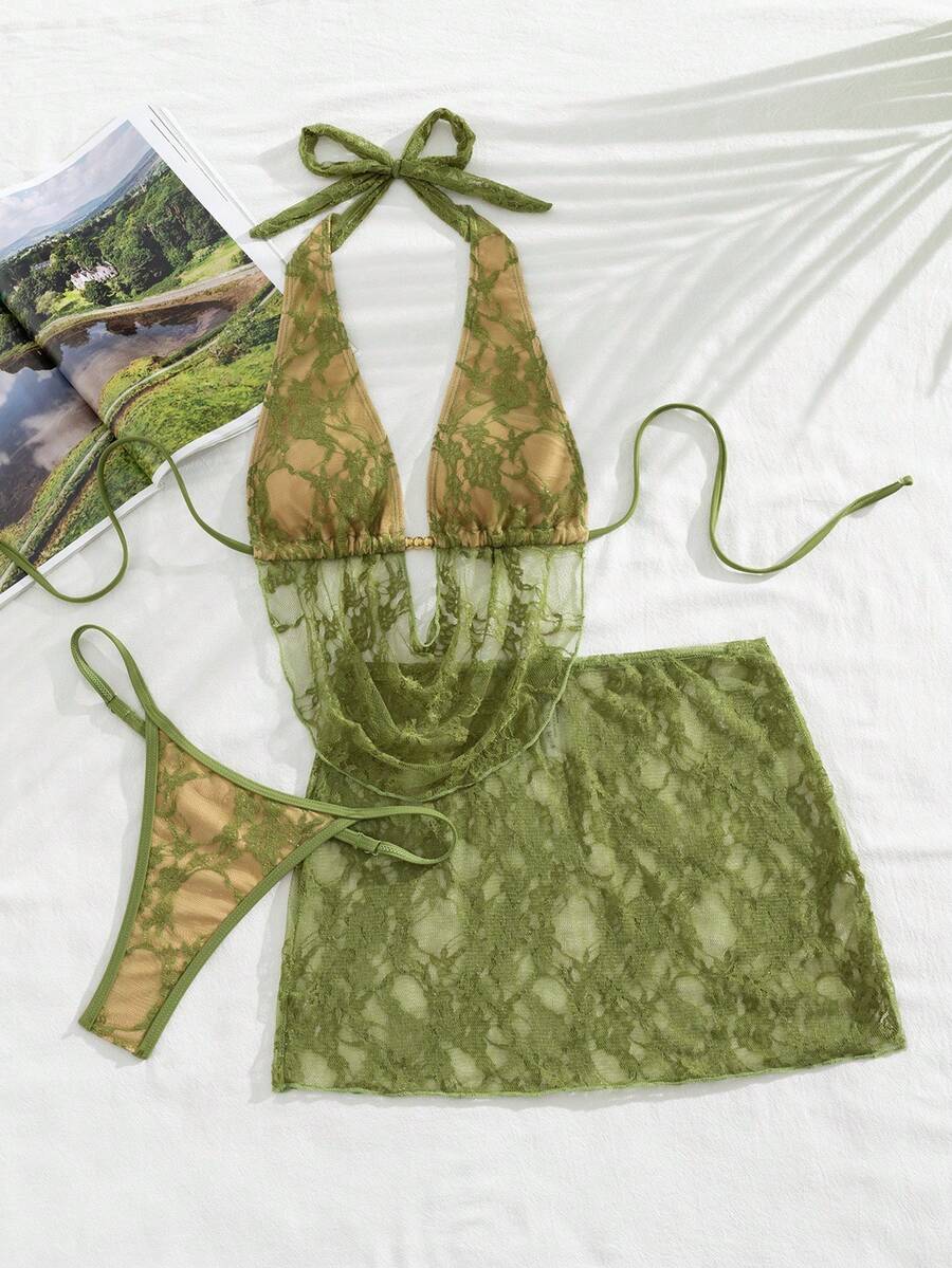 Women's black 3-piece bikini set with halter triangle top, backless design, ruched thong bottoms, and matching lace skirt for beach or vacation wear.