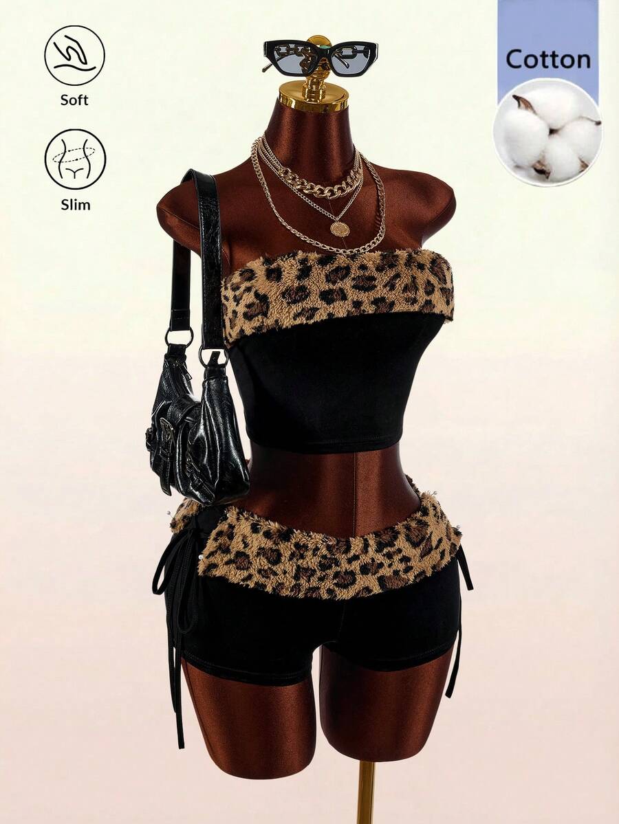 Women's black leopard print two-piece set with strapless bandeau crop top, knot and lace-up details, and matching mini shorts.