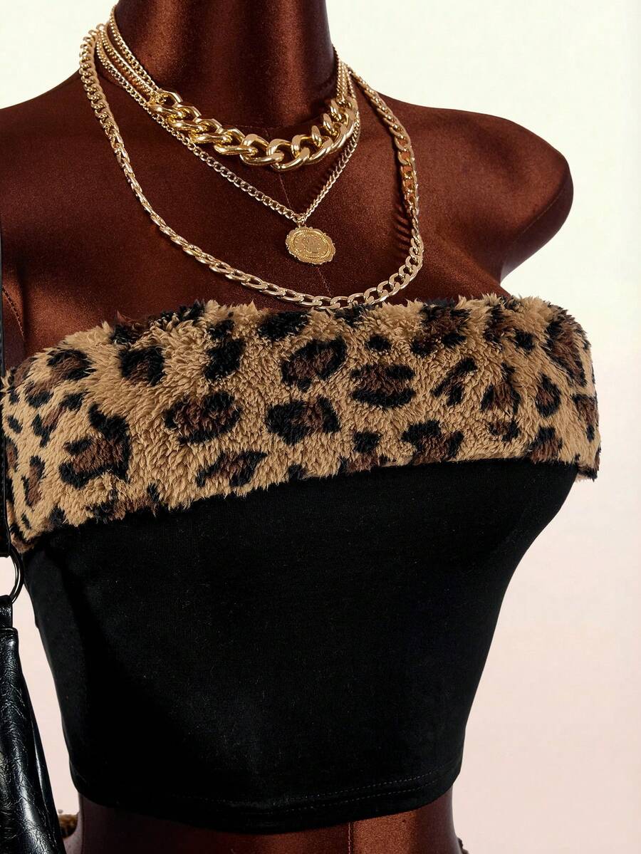 Women's black leopard print two-piece set with strapless bandeau crop top, knot and lace-up details, and matching mini shorts.