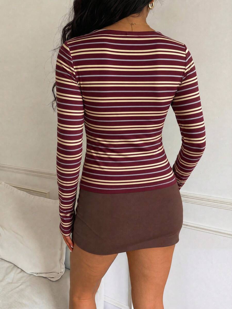Casual CovetEZ long sleeve T-shirt with leopard-style random print, round neck, loose fit, and asymmetrical detail