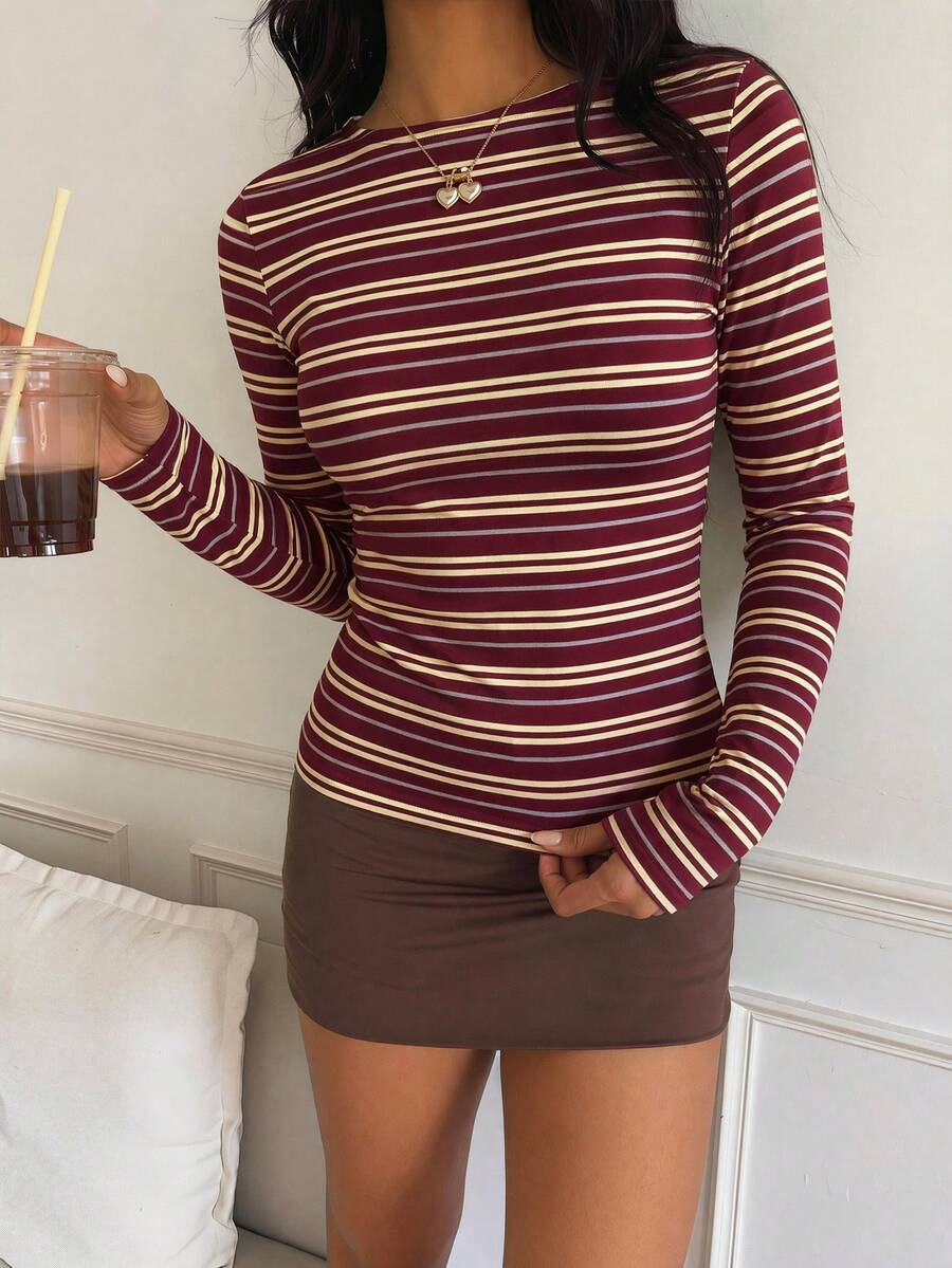 Casual CovetEZ long sleeve T-shirt with leopard-style random print, round neck, loose fit, and asymmetrical detail
