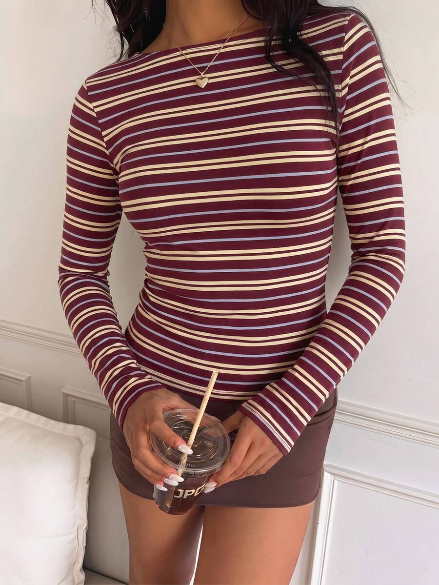 Casual CovetEZ long sleeve T-shirt with leopard-style random print, round neck, loose fit, and asymmetrical detail