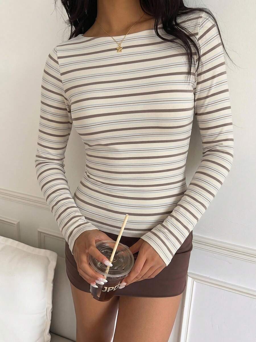 Casual CovetEZ long sleeve T-shirt with leopard-style random print, round neck, loose fit, and asymmetrical detail