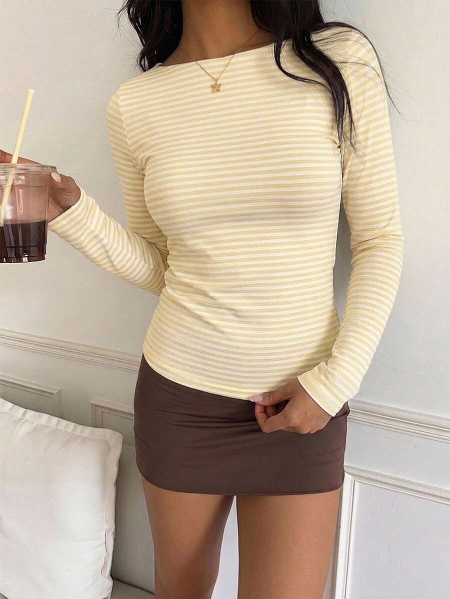 Casual CovetEZ long sleeve T-shirt with leopard-style random print, round neck, loose fit, and asymmetrical detail
