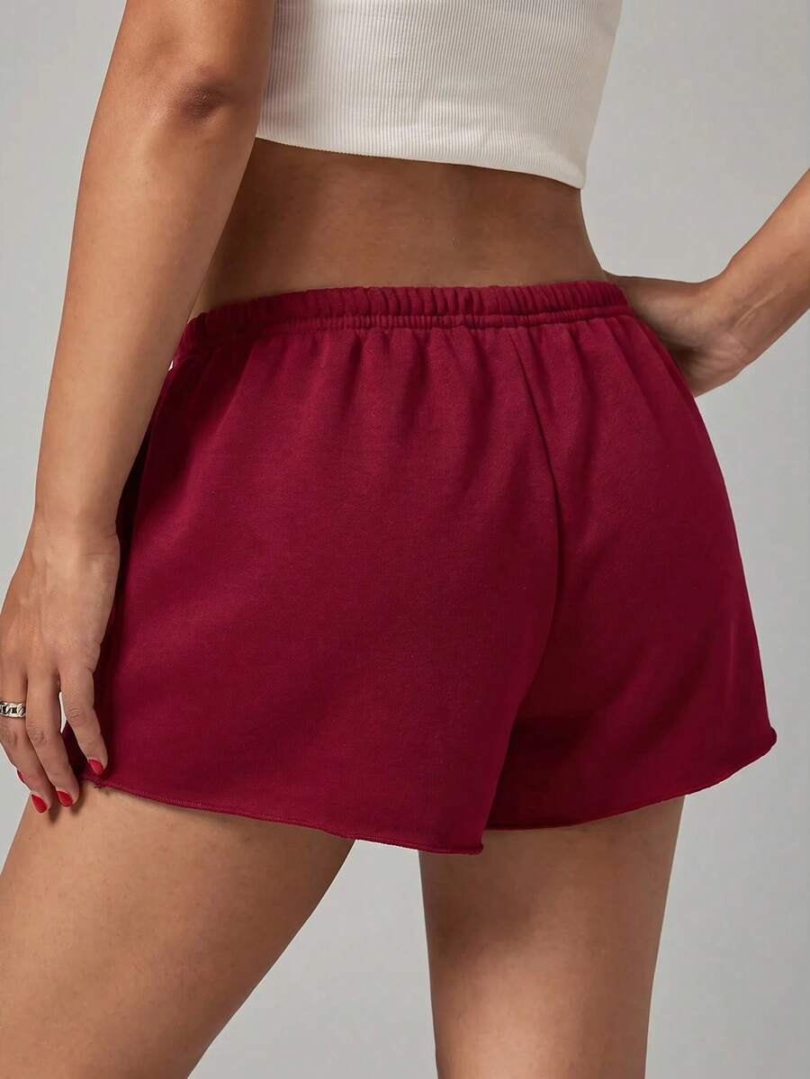 Petite women's burgundy casual track shorts with drawstring waist, raw hem, loose fit, and mini length